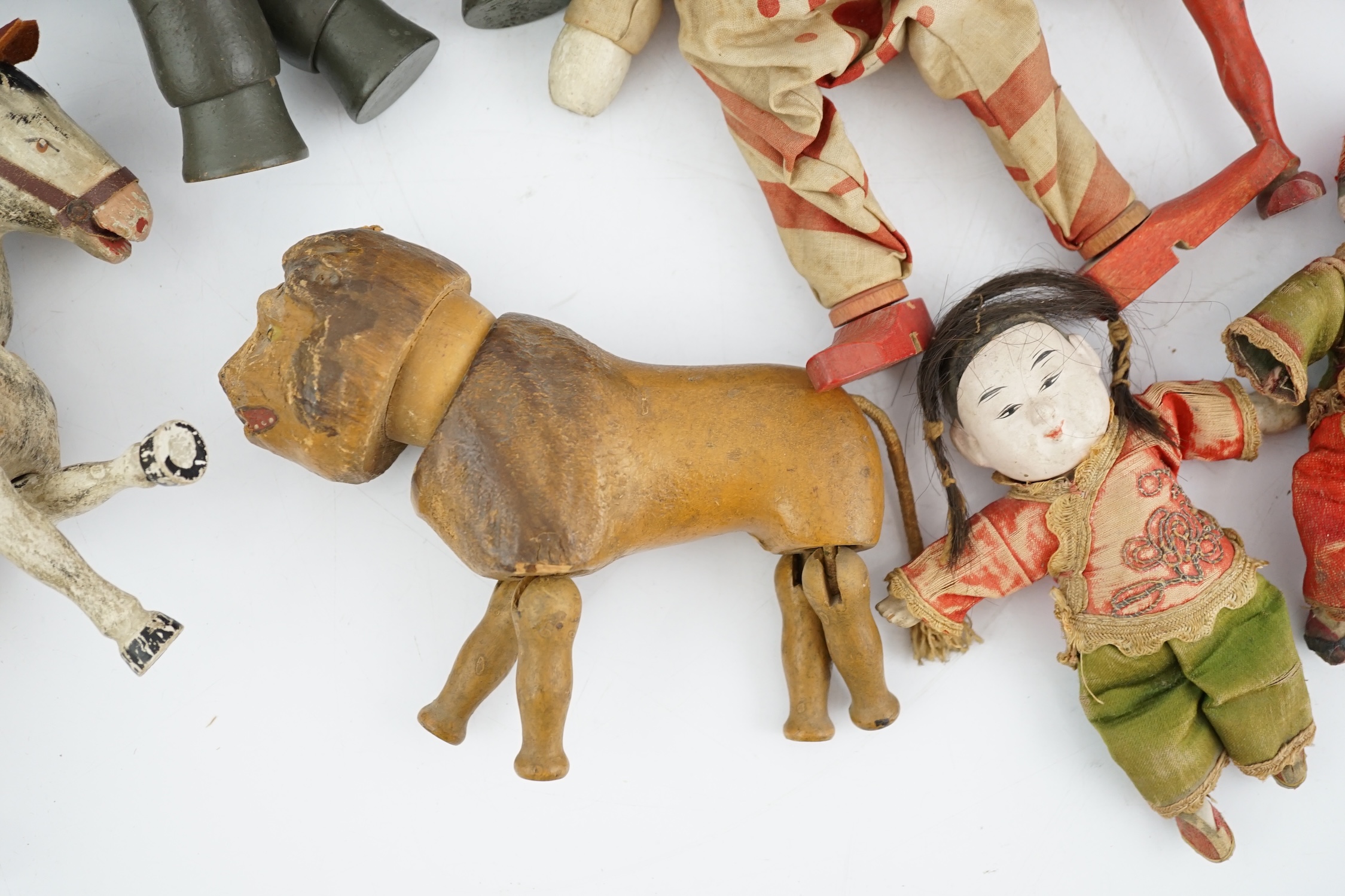 A Schoenhut Humpty Dumpty Circus, early 20th century, including elephant, lion house and other pieces, a playbarn (10) plus a peg doll and a German tinplate clockwork dog